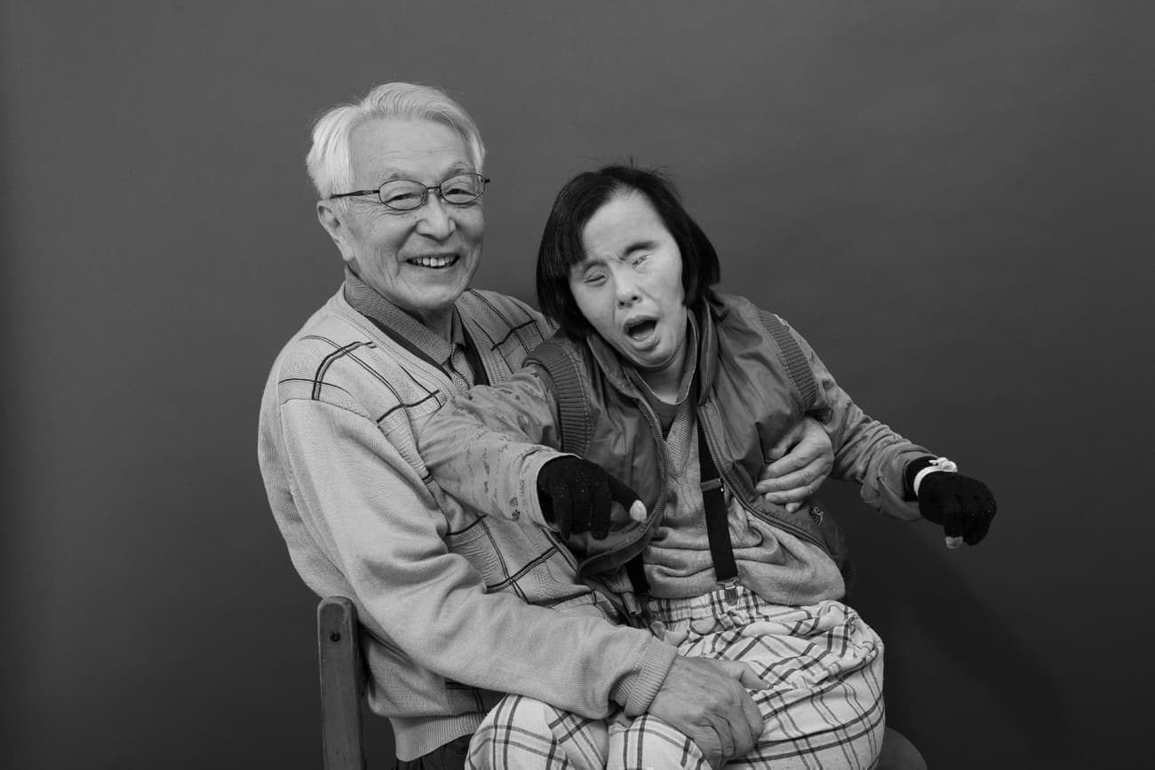 ダウン症の娘を抱く父